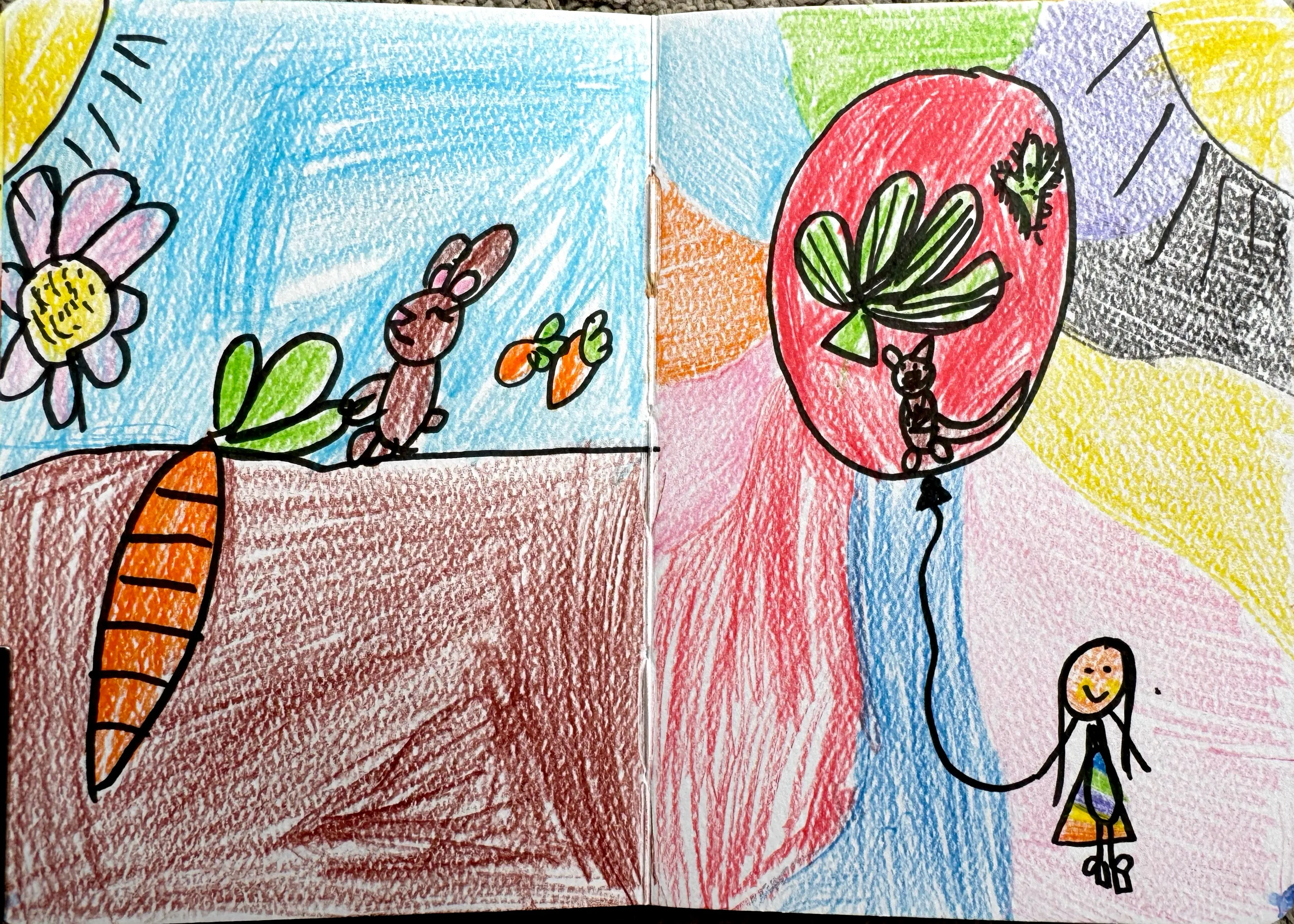 A child's colourful crayon drawing spread across two pages showing a rabbit with carrots growing in soil on the left, and a small girl holding a large red balloon decorated with leaves and a tiny rabbit on the right
